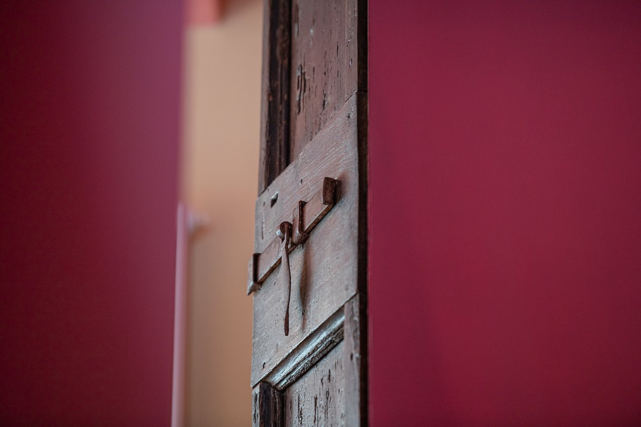 Ancient wooden doors set into the stone walls of the medieval village of Acquaviva.